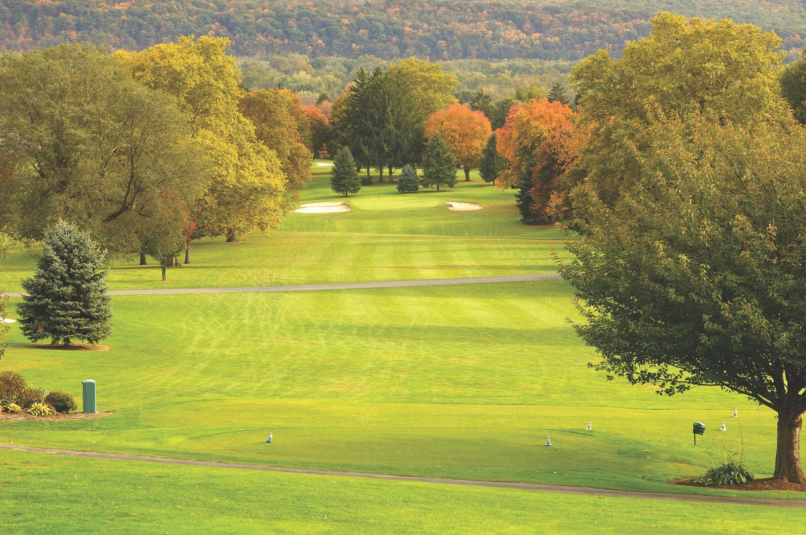 Sunlit fairway and clubhouse at Susquehanna Valley Country Club